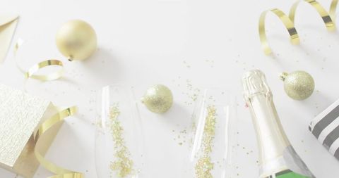 Gold New Year Celebration with Champagne Flutes Toasting, Glitter Confetti, Ornaments