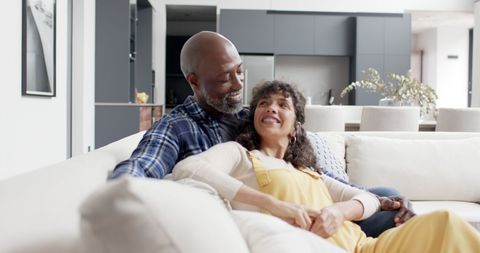Mature Couple Embracing on Modern Cozy Sofa