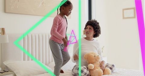 Mother and daughter playing on bed in pajamas holding teddy bear with neon overlays