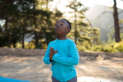 Serene Child Meditating in Forest
