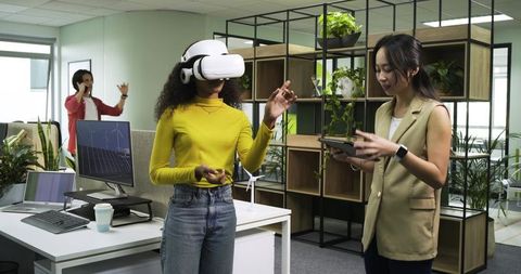 Diverse Team Engaged in VR Technology in Modern Office