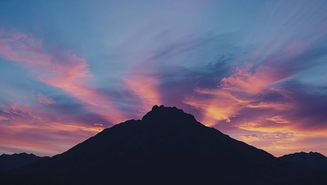 Majestic Mountain Silhouette under Colorful Sunrise Sky