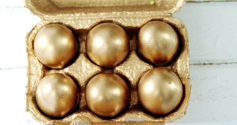 Golden Easter Eggs in Carton on Wooden Surface - Download Free Stock Images Pikwizard.com