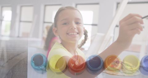 Cheerful Schoolgirl Painting Enthusiastically in Art Class - Download Free Stock Images Pikwizard.com