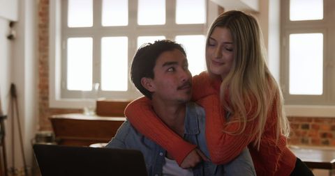 Happy Couples at Home, Relaxing with a Laptop