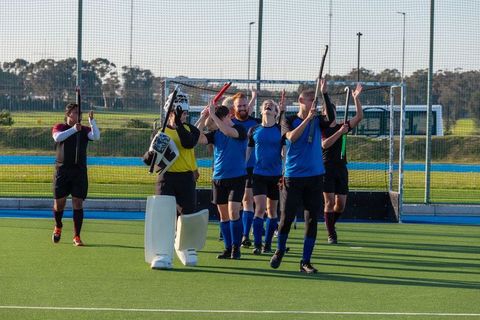 Unified Field Hockey Team Celebrating Victory on Turf
