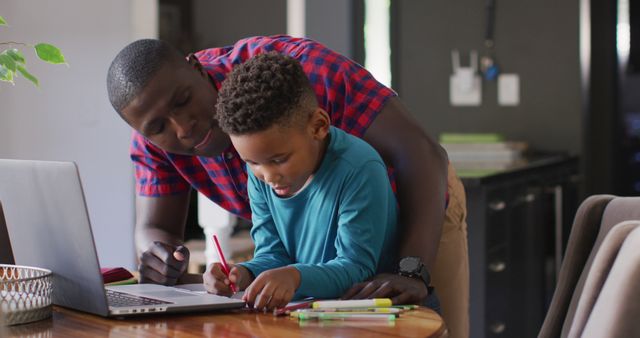 Image of african american father helping son in homework. Childhood, family, education, spending time at home concept.