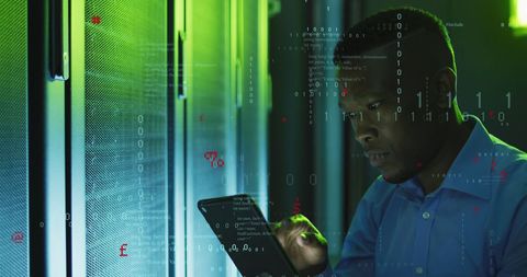African american it engineer analyzing data on tablet in server room