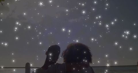 Romantic Couple Under Starry Sky at Sunset