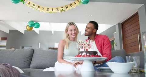 Couple Celebrating Birthday with Cake at Home