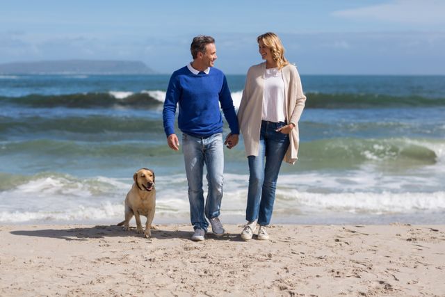 Mature Couple Walking on Beach with Dog - Download Free Stock Photos Pikwizard.com