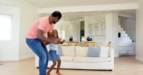 Joyful Father Daughter Dance Time in Bright Living Room