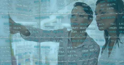 Businesswomen Analyzing Digital Financial Data Board