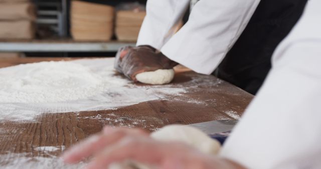 Bakers kneading dough on a wooden table in kitchen - Download Free Stock Images Pikwizard.com