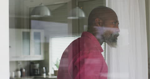 Thoughtful Man Gazing Through Window on Tranquil Morning