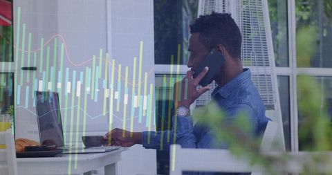 Businessman Using Laptop and Smartphone at Cafe with Stock Charts Overlay