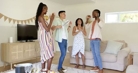 Diverse Friends Dancing and Celebrating at Home