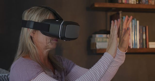 Senior Woman Immersed in Virtual Reality at Home Experiencing Technology - Download Free Stock Images Pikwizard.com