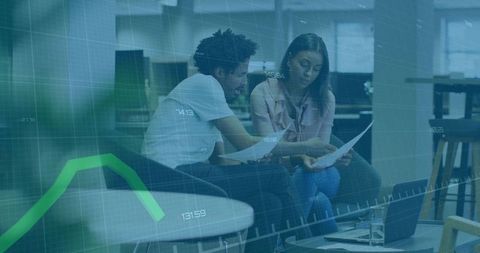 Professional Coworkers Analyzing Charts in Modern Office Setting