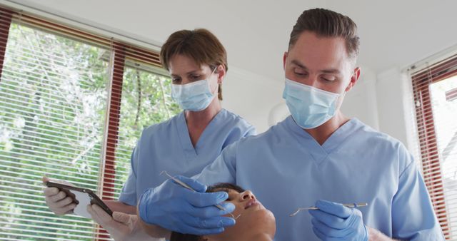 Dentists Performing Examination on Patient with Dental Tools - Download Free Stock Images Pikwizard.com