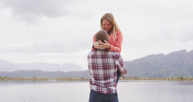 Young Couple Embracing by Lake with Mountain View - Download Free Stock Photos Pikwizard.com