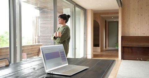 Woman Enjoying Tranquil Moment in Modern Home Office