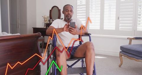 Elderly Man Using Smartphone While Analyzing Graphs on Wheelchair