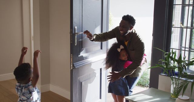 African American Father Arriving Home Hugging Daughter as Son Excitedly Welcomes - Download Free Stock Images Pikwizard.com