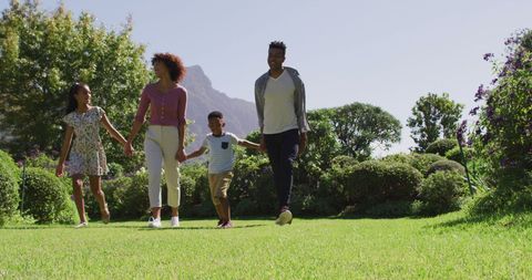 Happy African American Family Walking in Sunny Garden