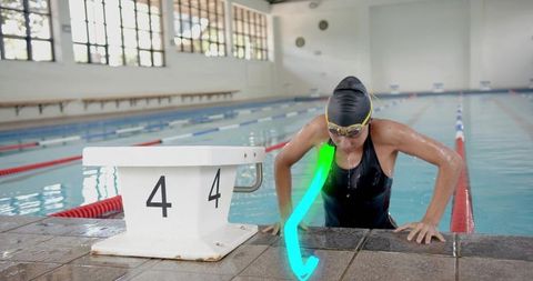 Female Swimmer Emerging from Pool Showing Determination