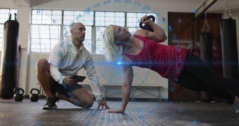 Woman practicing kettlebell routine with digital interface