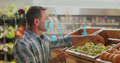 Mid-adult Man Selecting Green Apples with Augmented Reality Overlay in Supermarket