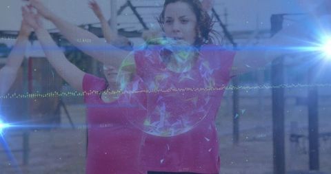 Woman Leading Group Exercise Wearing Fitness Technology Outdoors