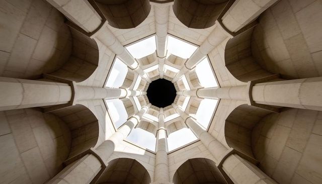 Octagonal stone cupola with radial colonnade and central oculus revealing geometric vault