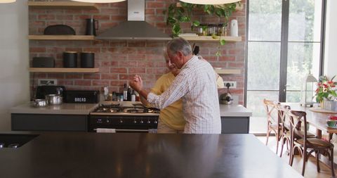 Senior Couple Dancing in Modern Rustic Kitchen