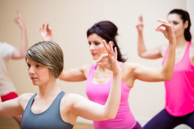 Group of people performing gyan mudra in the fitness studio