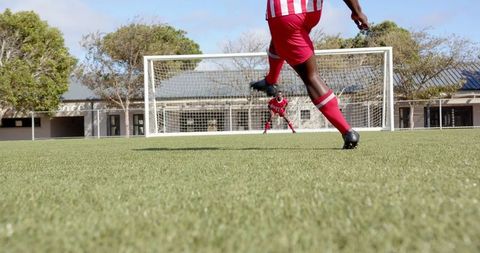 Intense Soccer Match with Focused Goalkeeper on Green Turf