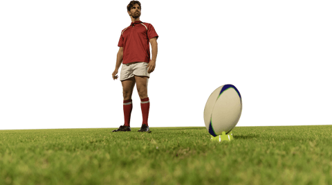 Caucasian rugby player in red uniform standing on green field - transparent background