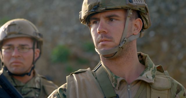 Shows soldiers focused on an operation, wearing camouflage uniforms and helmets outdoors. Ideal for use in articles about military training, war strategies, and defense mechanisms. Useful for recruitment campaigns, documentaries on armed forces, and security-themed publications.