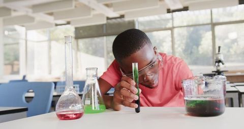 Curious Boy Conducting Experiment with Test Tube in Science Classroom