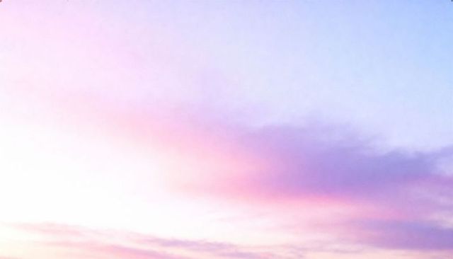 Glowing pastel sunrise gradient with pink and lavender clouds, serene dreamy sky