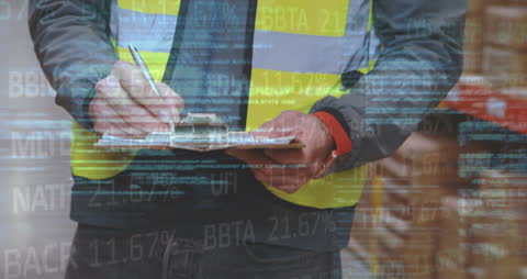 Warehouse Worker Analyzing Data with Financial Metrics Overlay