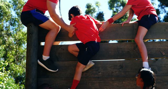 Team Building Activity with Young People Climbing Wooden Wall Outdoors - Download Free Stock Images Pikwizard.com