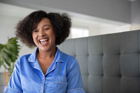 Joyful woman in relaxing pajamas enjoying morning tranquility