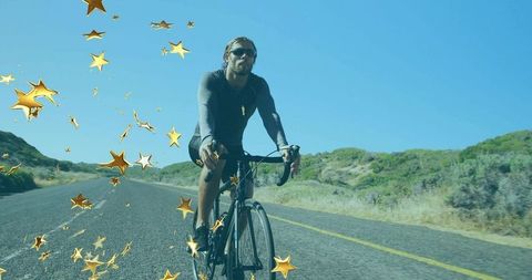 Cyclist Riding Rural Highway with Glimmering Stars Around