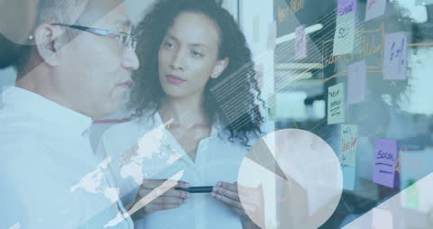 Multiracial Coworkers Collaborating with Digital Interface in Office