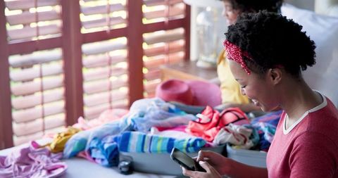 Couple packing suitcase at home for a vacation