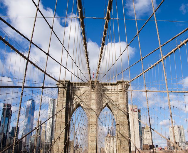 Featuring the iconic Brooklyn Bridge with Manhattan skyline in background under clear blue sky. Ideal for promoting travel to New York City, creating architectural presentations, or highlighting iconic landmarks. Perfect for brochures, travel guides, and cityscape displays.