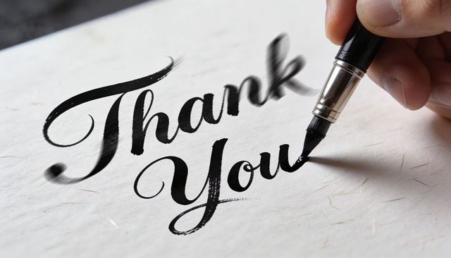 Writing Thank You Calligraphy with Black Brush Pen on Textured Paper for Greeting Cards