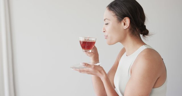 Woman Enjoying Hot Beverage in Minimalistic Setting - Download Free Stock Images Pikwizard.com